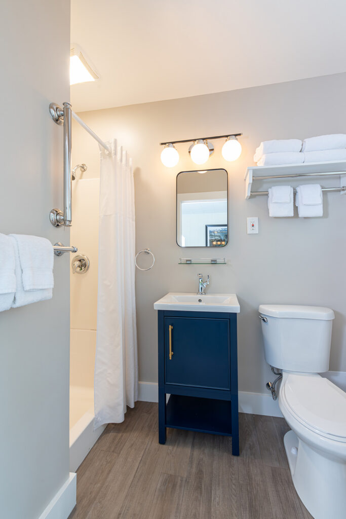 a clean bathroom with a toilet, sink, and shower