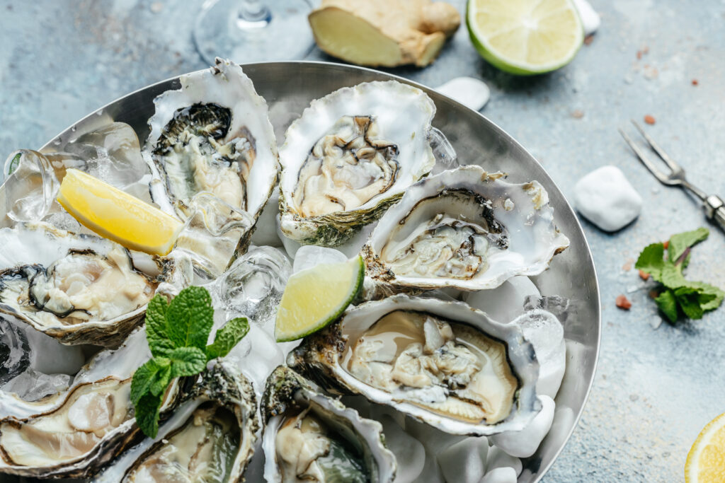 Fresh oysters on ice with lemon and lime